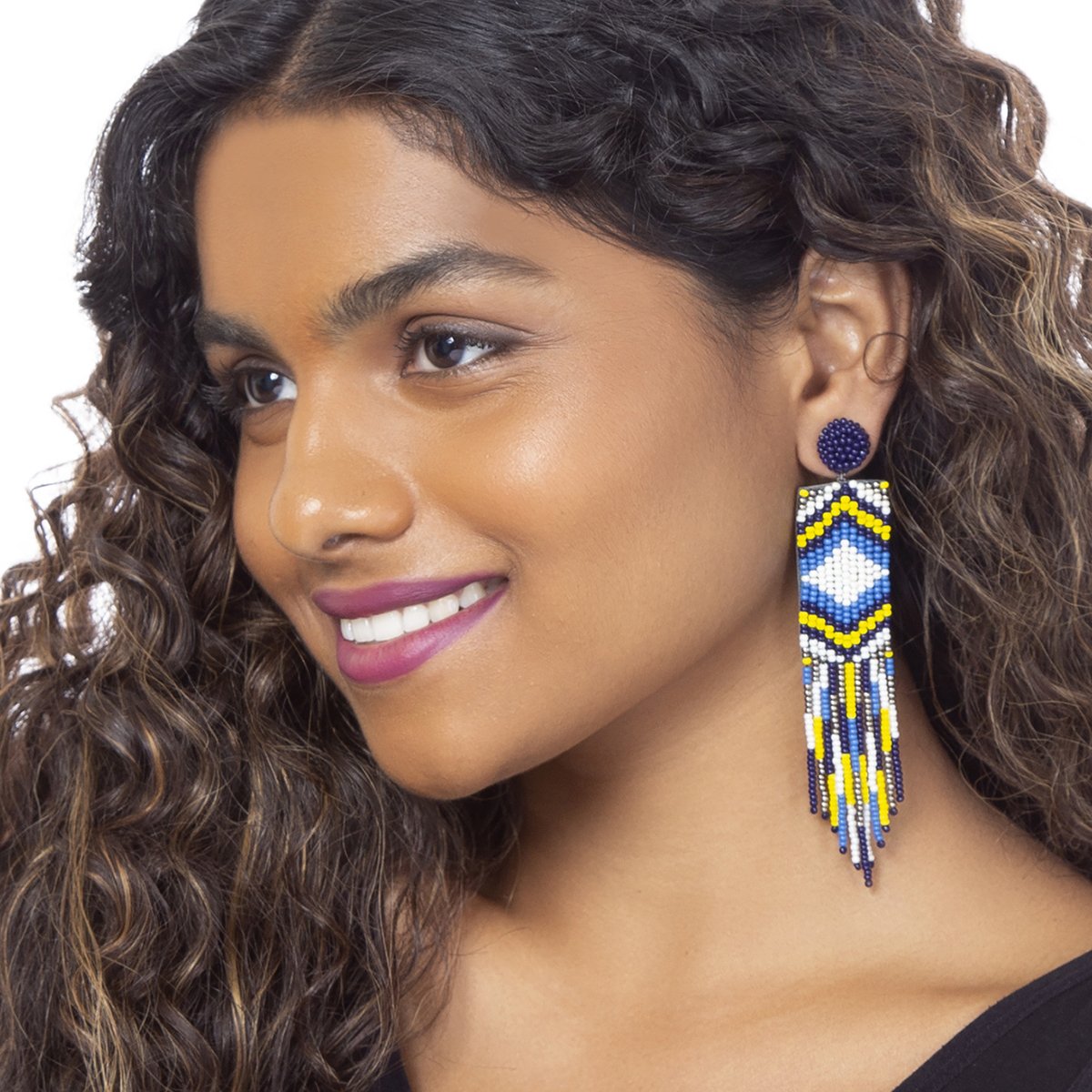 Model wearing handmade blue beaded earrings