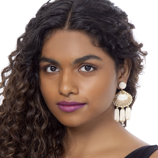 Model wearing handmade gold beaded shell earrings