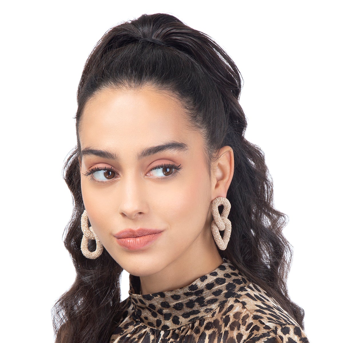 Model wearing two link beaded post earrings in champagne color