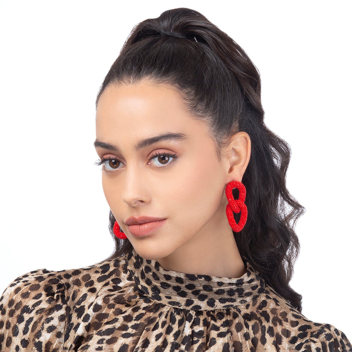 Model wearing two link beaded post earrings in red color