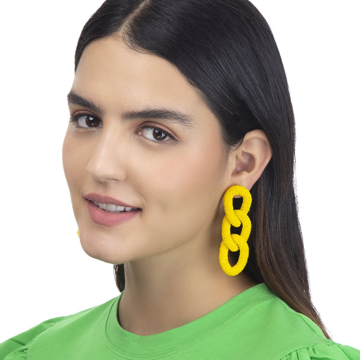 Model wearing yellow beaded three link earrings